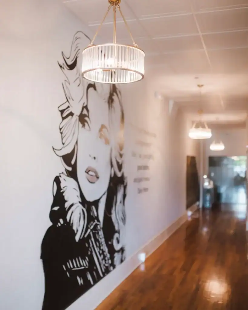 Modern interior of Brooke Nix Medical Aesthetics clinic with stylish wall art, elegant lighting, and warm hardwood flooring, creating a welcoming environment for skincare and aesthetic treatments.